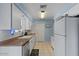 Functional kitchen with white cabinets, stainless steel appliances, and tile floors at 639 N 57Th Pl, Mesa, AZ 85205