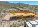Aerial view of desert home under construction, with wood framing, partial roof and desert landscape at 7646 E Hidden Canyon St, Mesa, AZ 85207