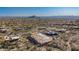 Aerial view of a home under construction nestled in a sprawling desert community at 7646 E Hidden Canyon St, Mesa, AZ 85207