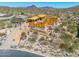 Home under construction showcasing wood framing with desert landscaping and brick work around base at 7646 E Hidden Canyon St, Mesa, AZ 85207