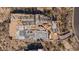 Aerial view of a home under construction, revealing its framing and layout amidst desert landscape at 7646 E Hidden Canyon St, Mesa, AZ 85207