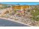 Home under construction showcasing wood framing with desert landscaping and brick work around base at 7646 E Hidden Canyon St, Mesa, AZ 85207