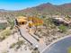 Home under construction featuring desert landscaping, wood framing and a private drive on a sunny day at 7646 E Hidden Canyon St, Mesa, AZ 85207