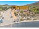 Home under construction featuring desert landscaping, wood framing and a private drive on a sunny day at 7646 E Hidden Canyon St, Mesa, AZ 85207