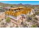 Home under construction showcasing wood framing with desert landscaping and brick work around base at 7646 E Hidden Canyon St, Mesa, AZ 85207