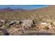Aerial view of a house under construction in a desert setting, surrounded by mountains at 7646 E Hidden Canyon St, Mesa, AZ 85207