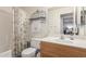 Bathroom featuring a vanity with wood cabinets and a shower-tub with floral curtain at 8140 N 107Th Ave # 120, Peoria, AZ 85345