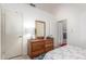 Bright bedroom featuring a dresser with mirror and doorway to another room at 8140 N 107Th Ave # 120, Peoria, AZ 85345