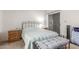 Bedroom featuring a stylish bed, two nightstands, and sliding glass door at 8140 N 107Th Ave # 120, Peoria, AZ 85345