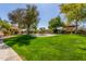 Lush community green space featuring picnic tables, mature trees, and manicured lawn at 8140 N 107Th Ave # 120, Peoria, AZ 85345