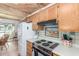Kitchen featuring tiled backsplash, wood cabinets, and views of the breakfast area at 8140 N 107Th Ave # 120, Peoria, AZ 85345