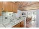 Open concept kitchen with adjoining breakfast nook with wood-paneled ceiling at 8140 N 107Th Ave # 120, Peoria, AZ 85345