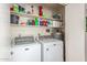 Well-stocked laundry room with white washer, dryer, water heater and shelving at 8140 N 107Th Ave # 120, Peoria, AZ 85345