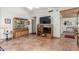 Bright living room showcasing tiled floors, a built-in display cabinet, and a spacious layout at 8140 N 107Th Ave # 120, Peoria, AZ 85345