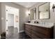Elegant bathroom with double sink vanity featuring modern fixtures, wall sconces, and dark tile floor at 8424 E San Bernardo Dr, Scottsdale, AZ 85258