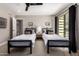 Bright bedroom with two twin beds, ceiling fan, private balcony, and ensuite bath at 8424 E San Bernardo Dr, Scottsdale, AZ 85258