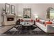 Inviting living room with a fireplace, stylish decor, and a large mirror reflecting the home's elegant interior at 8424 E San Bernardo Dr, Scottsdale, AZ 85258
