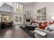 Spacious living room with high ceilings, a cozy fireplace, hardwood floors, and lots of natural light at 8424 E San Bernardo Dr, Scottsdale, AZ 85258
