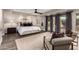 Relaxing main bedroom features a sitting area, dark wood floors, king bed, and view to the back yard at 8424 E San Bernardo Dr, Scottsdale, AZ 85258