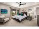 Comfortable main bedroom with gray walls, queen size bed, ceiling fan, and a private balcony at 8424 E San Bernardo Dr, Scottsdale, AZ 85258