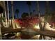 Outdoor pool with a beautiful bougainvillea climbing the nearby walls, lit by the landscape lighting at 8424 E San Bernardo Dr, Scottsdale, AZ 85258