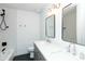 Elegant bathroom with double sinks, modern fixtures, and a bathtub-shower combination with tiled walls at 8621 E Vista Dr, Scottsdale, AZ 85250