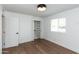 Comfortable bedroom featuring hardwood floors, a closet, a window with curtains, and simple decor at 8621 E Vista Dr, Scottsdale, AZ 85250