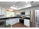 Well-lit kitchen featuring granite countertops, stainless steel appliances, and white cabinets with a window at 8621 E Vista Dr, Scottsdale, AZ 85250