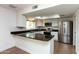 Well-lit kitchen featuring granite countertops, stainless steel appliances, and white cabinets with a window at 8621 E Vista Dr, Scottsdale, AZ 85250