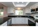 Well-lit kitchen featuring granite countertops, stainless steel appliances, and white cabinets with a window at 8621 E Vista Dr, Scottsdale, AZ 85250
