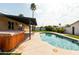 Backyard pool with spa, covered patio, and lush landscaping at 8621 E Vista Dr, Scottsdale, AZ 85250