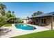 Backyard pool with artificial grass, brick home and solar panels at 8621 E Vista Dr, Scottsdale, AZ 85250
