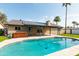 Backyard pool with spa, artificial grass, brick home and solar panels at 8621 E Vista Dr, Scottsdale, AZ 85250