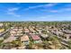 Expansive aerial view of a residential neighborhood with desert landscaping and mountain views at 903 W Raven Dr, Chandler, AZ 85286