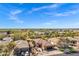 Expansive aerial view of a community featuring well-maintained homes, lush landscaping, and clear blue skies at 903 W Raven Dr, Chandler, AZ 85286