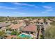 A stunning aerial shot showcasing a backyard pool with lush landscaping, surrounded by a vibrant neighborhood at 903 W Raven Dr, Chandler, AZ 85286