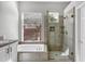 The bathroom has a soaking tub, glass enclosed shower, and a large window at 903 W Raven Dr, Chandler, AZ 85286