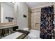 Cozy bathroom features a shower/tub combo with decorative shower curtain and a granite vanity at 903 W Raven Dr, Chandler, AZ 85286