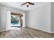 Sunlit bedroom with access to the pool, featuring wood-look floors and a ceiling fan at 903 W Raven Dr, Chandler, AZ 85286