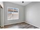 Bright bedroom features a window that provides ample natural light and wood-look floors at 903 W Raven Dr, Chandler, AZ 85286