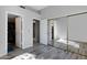 This bedroom features wood floors, ensuite bathroom, mirrored closet, and neutral paint at 903 W Raven Dr, Chandler, AZ 85286