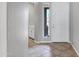 Bright entryway with tile flooring, white door, and view of desert landscape through the side window at 903 W Raven Dr, Chandler, AZ 85286