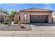 Attractive home with desert landscaping, a two-car garage, and a well-maintained lawn at 903 W Raven Dr, Chandler, AZ 85286