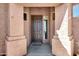 Inviting front entrance featuring a solid brown door, a Hello mat, and matching pillars for an immediate warm welcome at 903 W Raven Dr, Chandler, AZ 85286