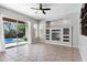 Bright living room featuring a ceiling fan, and direct access to the pool with built in shelves at 903 W Raven Dr, Chandler, AZ 85286