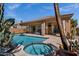 Outdoor pool and spa with desert landscaping, tile detail, and covered patio at 903 W Raven Dr, Chandler, AZ 85286