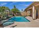 Sparkling pool features a spa, desert landscaping, and covered patio at 903 W Raven Dr, Chandler, AZ 85286