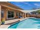Inviting pool area featuring a covered patio, comfortable seating, and serene backyard at 903 W Raven Dr, Chandler, AZ 85286