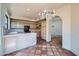 Bright kitchen with tile flooring, cabinets, countertops, modern appliances, and a decorative chandelier at 10062 E Cinnabar Ave, Scottsdale, AZ 85258