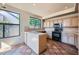 Charming kitchen featuring tile countertops and flooring, plus modern black appliances at 10062 E Cinnabar Ave, Scottsdale, AZ 85258